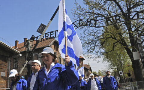 Participants of the yearly March of the Living walk through the "Arbeit Macht Frei" (work sets you free) entrance gate in the former German Nazi Death Camp Auschwitz-Birkenau, in Oswiecim, Poland, Monday, April 24, 2017. Jews from Israel and around the world marched the 3km route from Auschwitz to Birkenau commemorating the Holocaust victims. (AP Photo/Alik Keplicz)