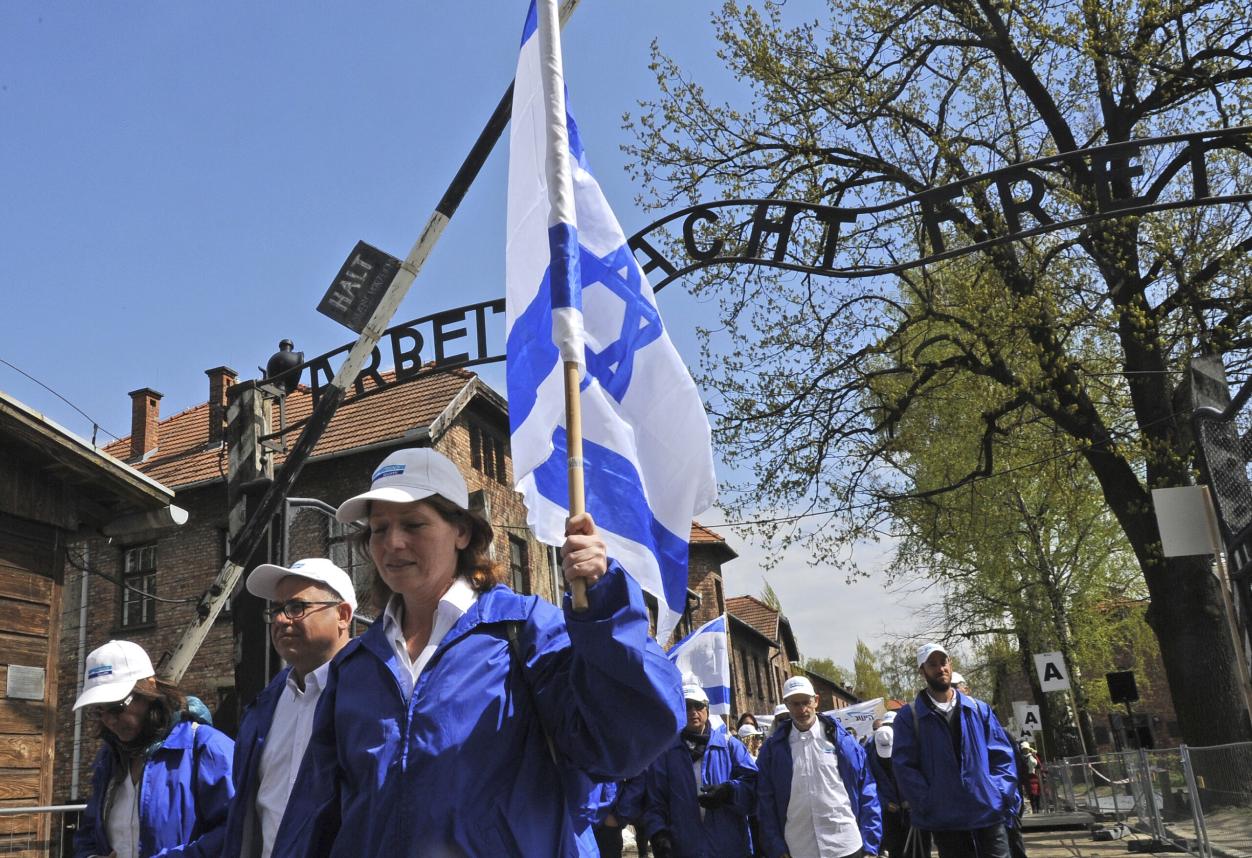 Participants of the yearly March of the Living walk through the "Arbeit Macht Frei" (work sets you free) entrance gate in the former German Nazi Death Camp Auschwitz-Birkenau, in Oswiecim, Poland, Monday, April 24, 2017. Jews from Israel and around the world marched the 3km route from Auschwitz to Birkenau commemorating the Holocaust victims. (AP Photo/Alik Keplicz)