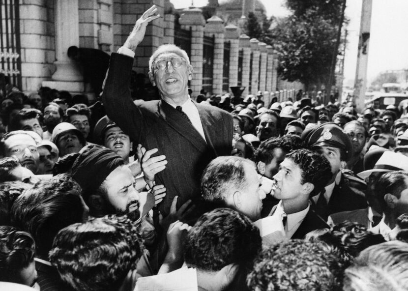 Sept. 27, 1951 file photo, Iranian Prime Minister Mohammad Mossadegh rides on the shoulders of cheering crowds in Tehran's Majlis Square, outside the parliament building, after reiterating his oil nationalization views to his supporters. In 2018, as Iran deals with President Donald Trump's decision to pull America from the nuclear deal with world powers, more are invoking the 1953 CIA-backed coup that toppled Mossadegh as proof the U.S. cannot be trusted. (AP Photo, File)